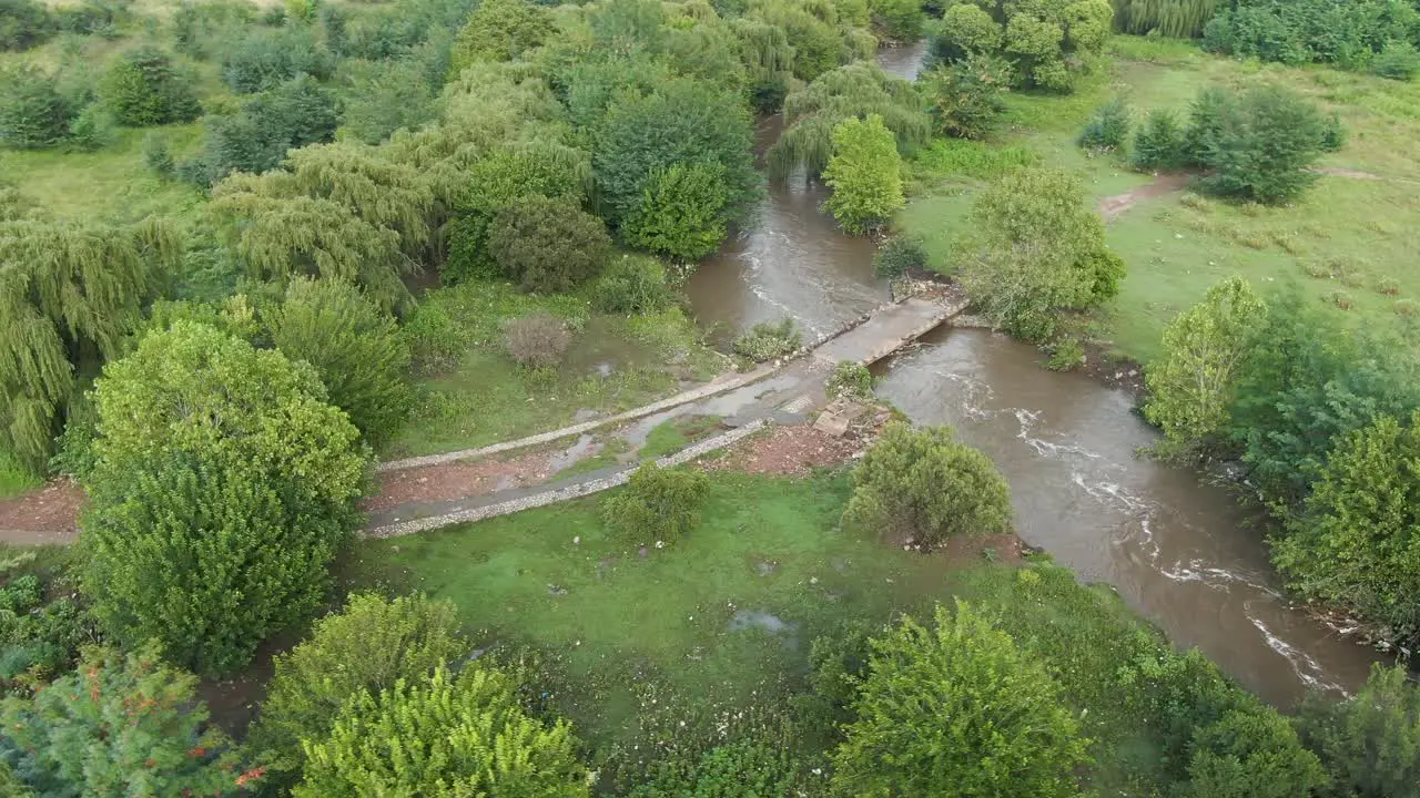 Small bridge over a river flooded after heavy rains