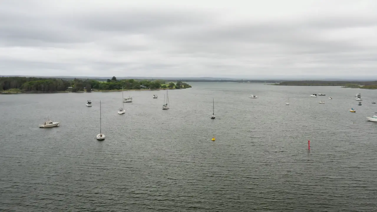 Aerial drone shot around boats moored on the Shoalhaven river near Shoalhaven heads south coast NSW Australia