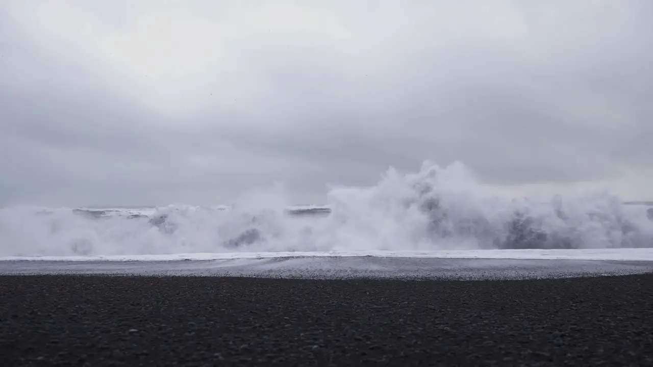 Storm waves crashing on Reynisfjara black sand beach in Iceland