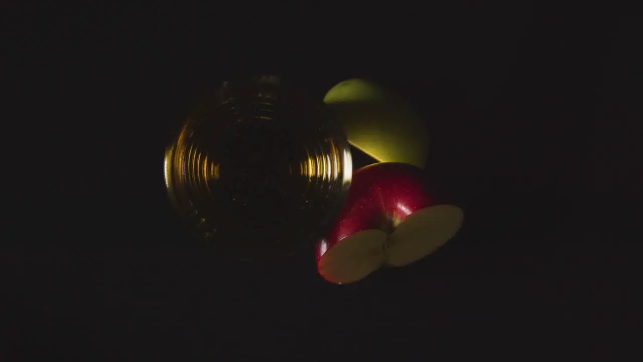 Overhead Shot Of Glass Of Apple Juice With Sliced Fresh Apples On Black Background