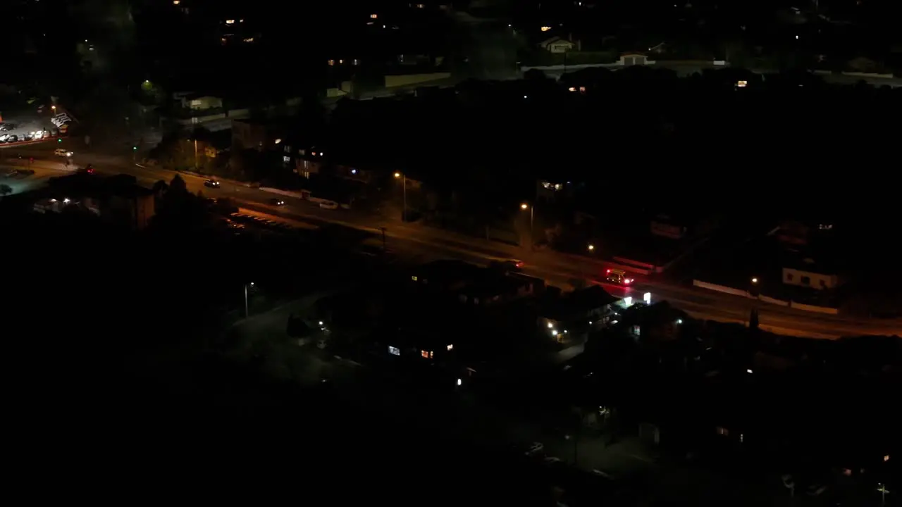 Drone view of vehicle with flashing lights going to emergency event