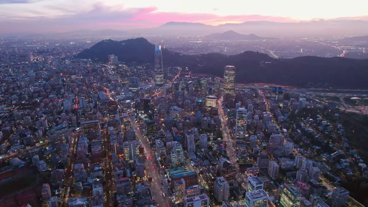 Aerial Panoramic Cityscape of Santiago Chile Providencia at Pink Sunset Andean Mountain Background Street City Lights and Skyscrappers