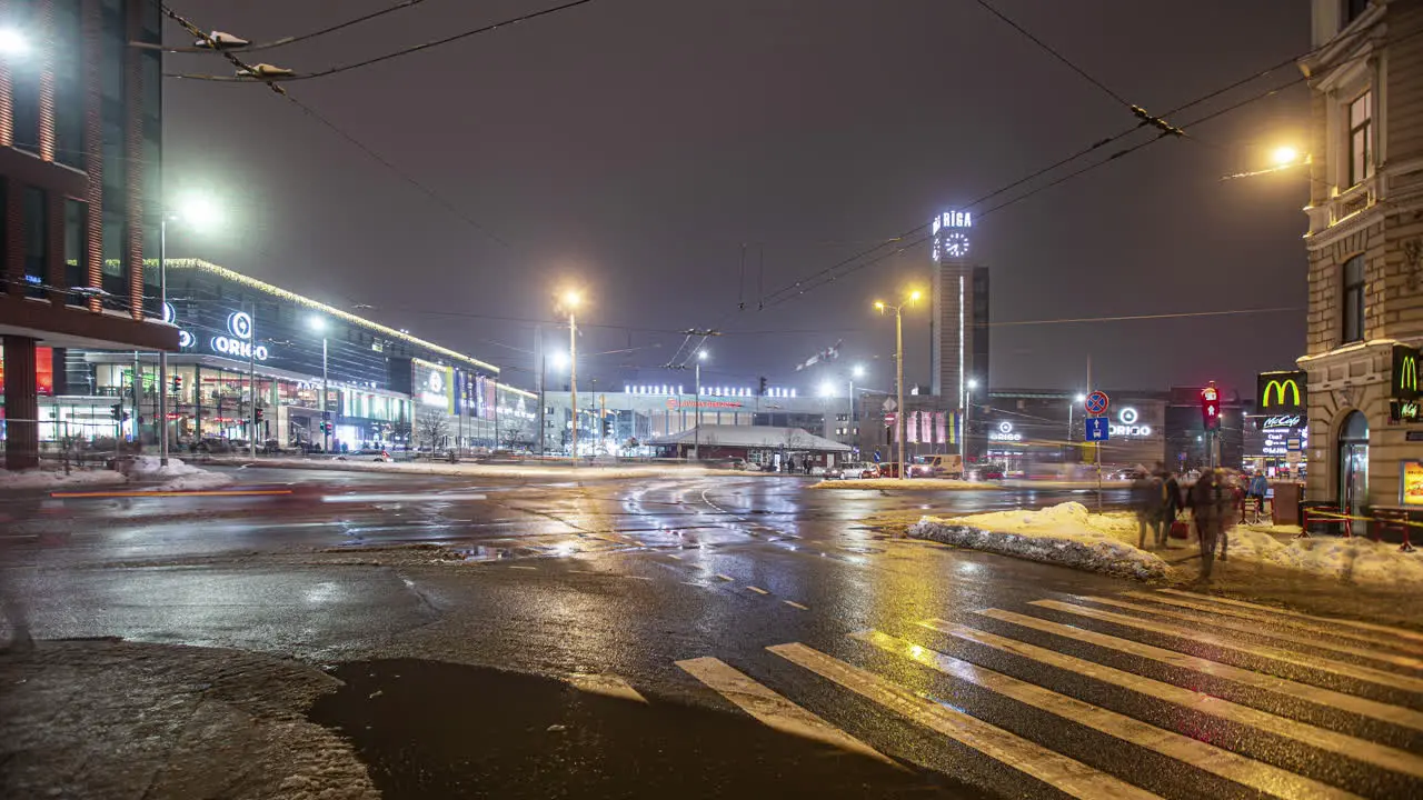 Night time shot of the traffic and pedestrians crossing the road in the city center