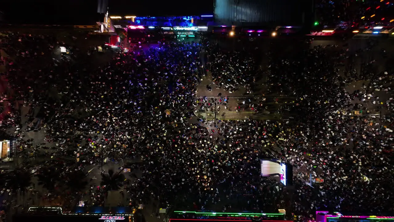 Aerial view above people at the San Marcos fair night in Aguascalientes Mexico top down drone shot