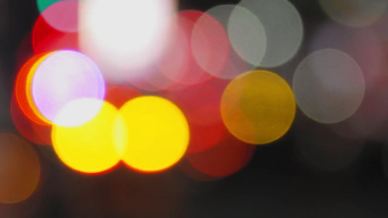 Rack Focus From Colorful Bokeh To Nighttime New York City Traffic Intersection