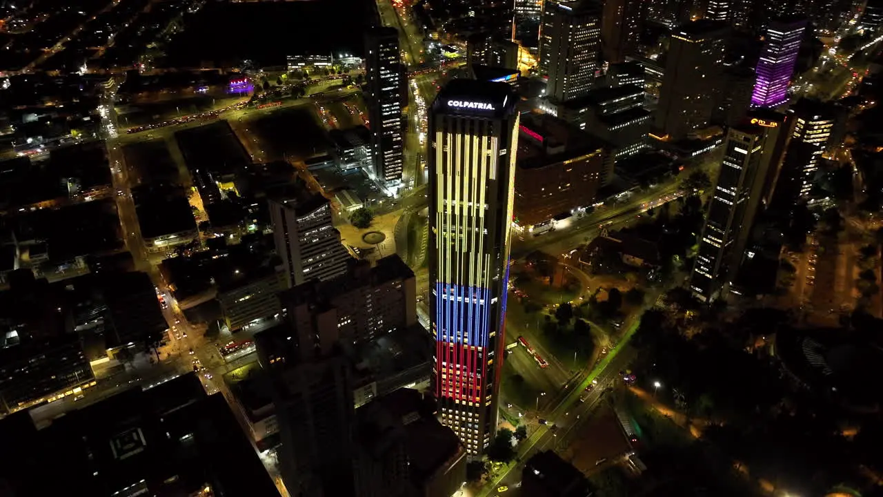 Aerial view around the illuminated Torre Colpatria tower night in Bogota Colombia