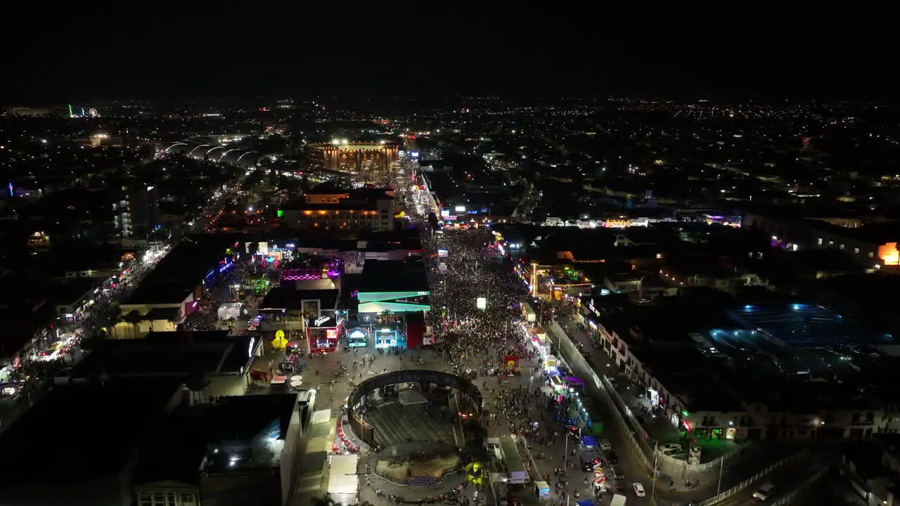 Aerial overview of night lit street at the San Marcos fair in Aguascalientes Mexico