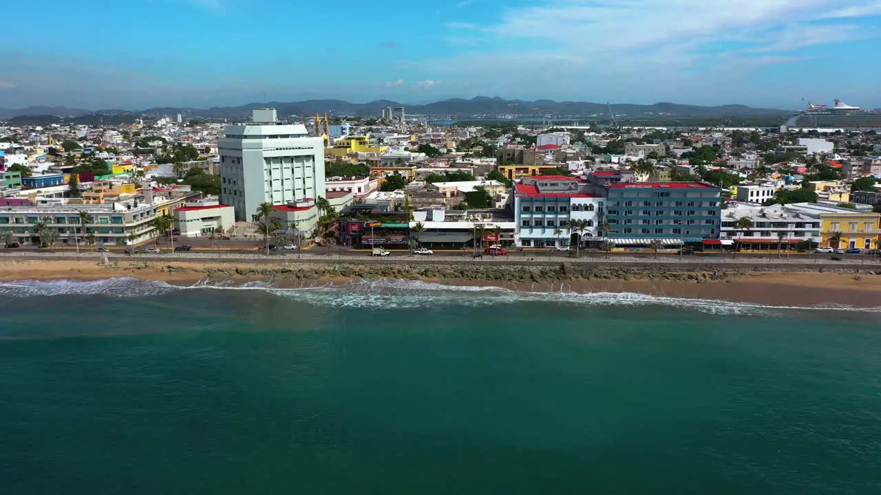 Aerial tracking shot of beaches and the cityscape of Mazatlan in sunny Mexico