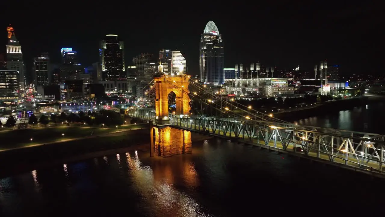 Aerial view around the Roebling Bridge with Cincinnati skyline in the background evening in Ohio USA circling drone shot