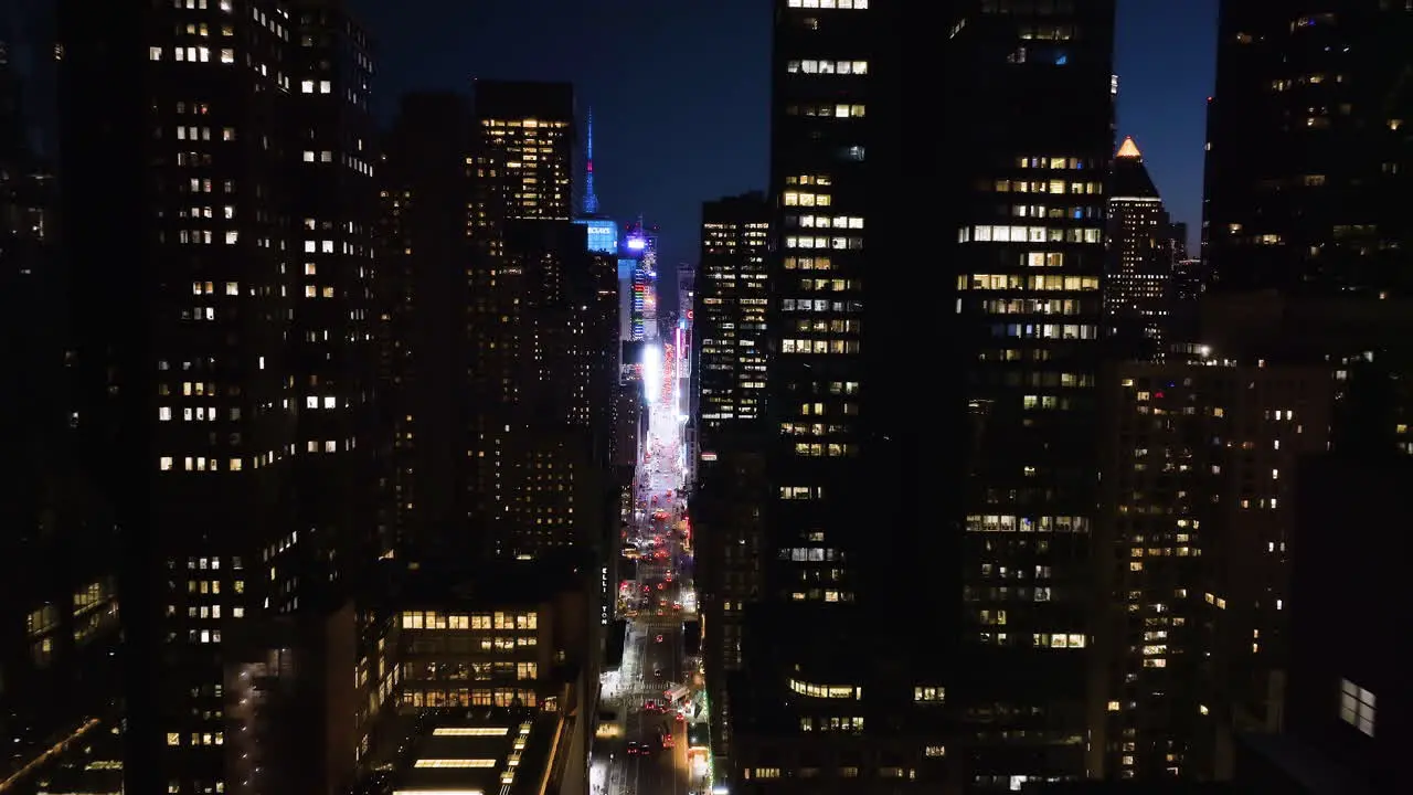 Aerial view in middle of buildings on the 7th ave toward Times square night in NY