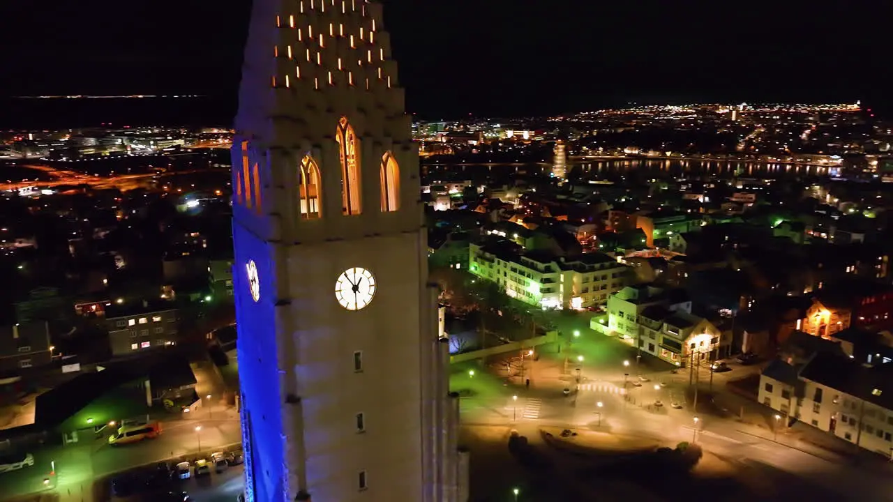 Aerial view descending in front of the tower of the Hallgrímskirkja church night in Reykjavik Iceland