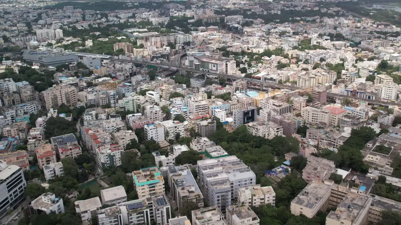 aerial views of a stadium nearby parallel railroad tracks and a metro station in the middle of the city