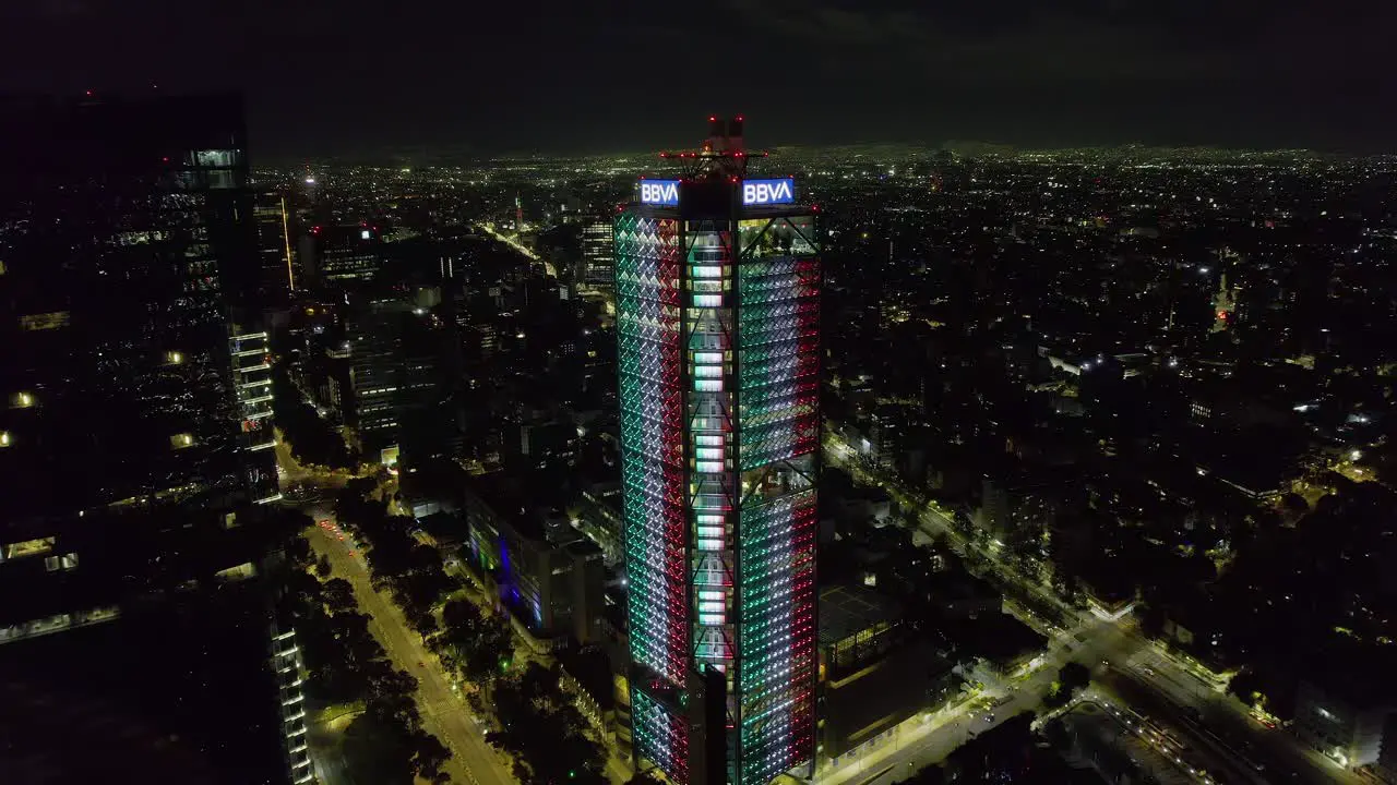 Aerial view towards the BBVA tower illuminated in the colors of the Mexican flag Independence day night in Mexico city