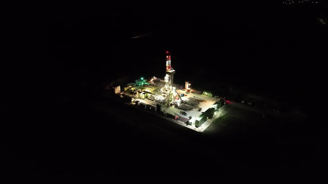 Panoramic View Over Illuminated Gas Drilling Station At Night drone shot