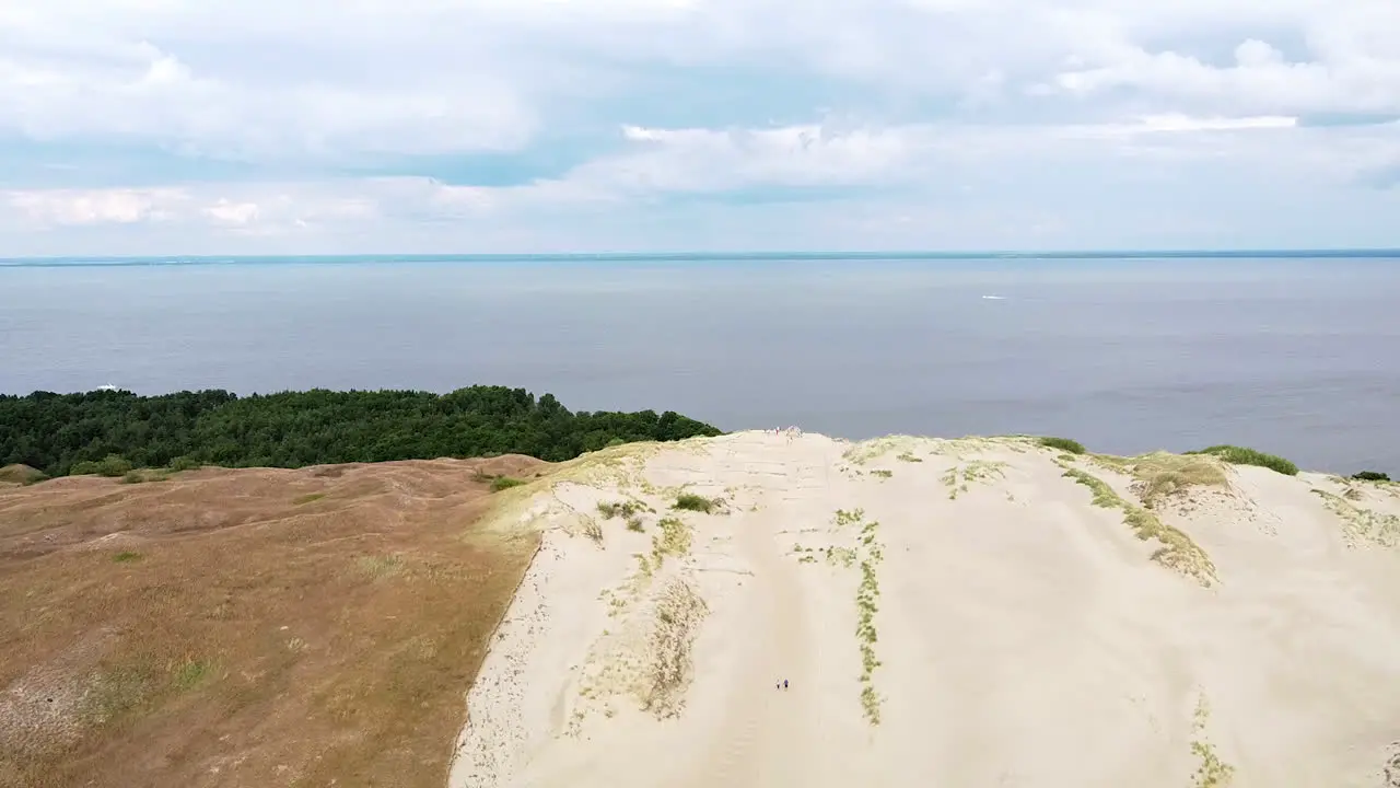 End of sandy dune with view to Curonian lagoon drone descending view