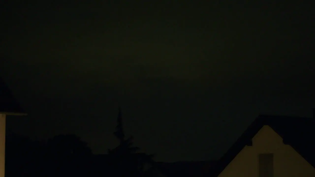 Looking out of a window at night during a thunderstorm