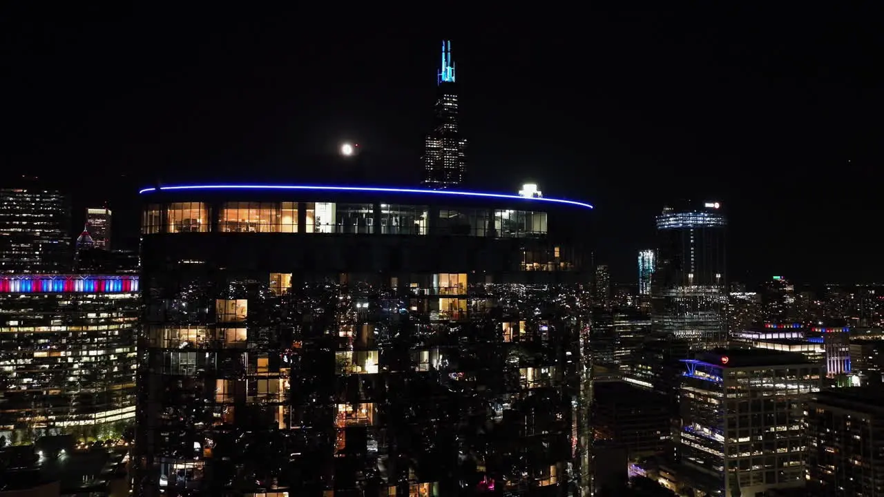 Aerial view of urban city life inside a reflecting condo revealing the Sears tower night in Chicago USA