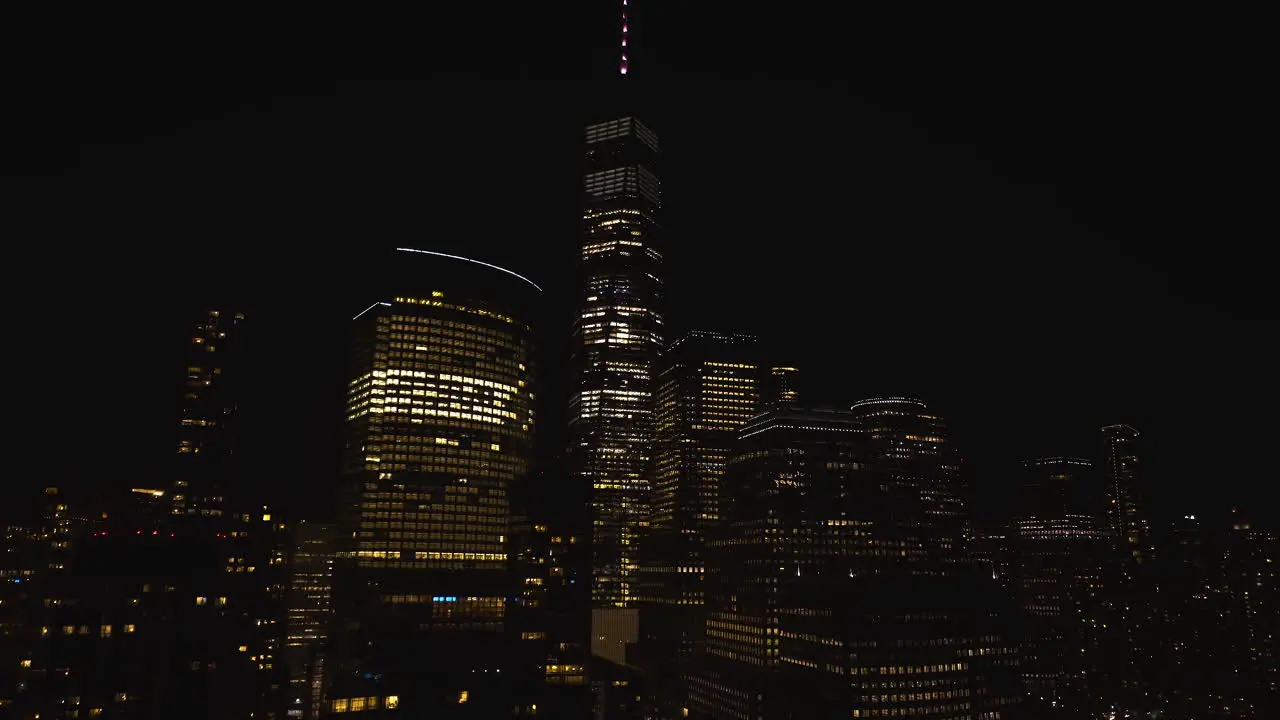 Ascending aerial view in front of the illuminated One World Trade Center in Manhattan New York USA