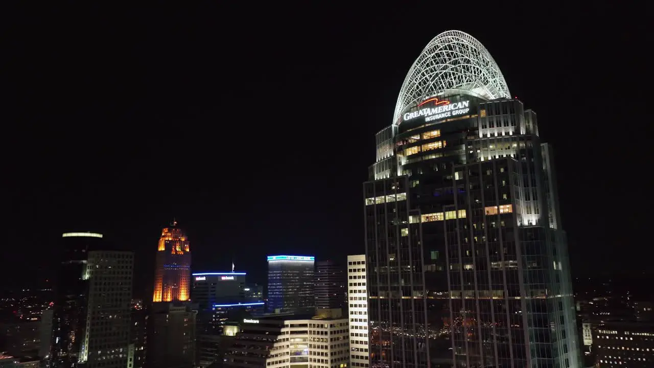 Aerial view away from the illuminated Great American Tower at Queen City Square revealing the night skyline of Cincinnati Ohio USA