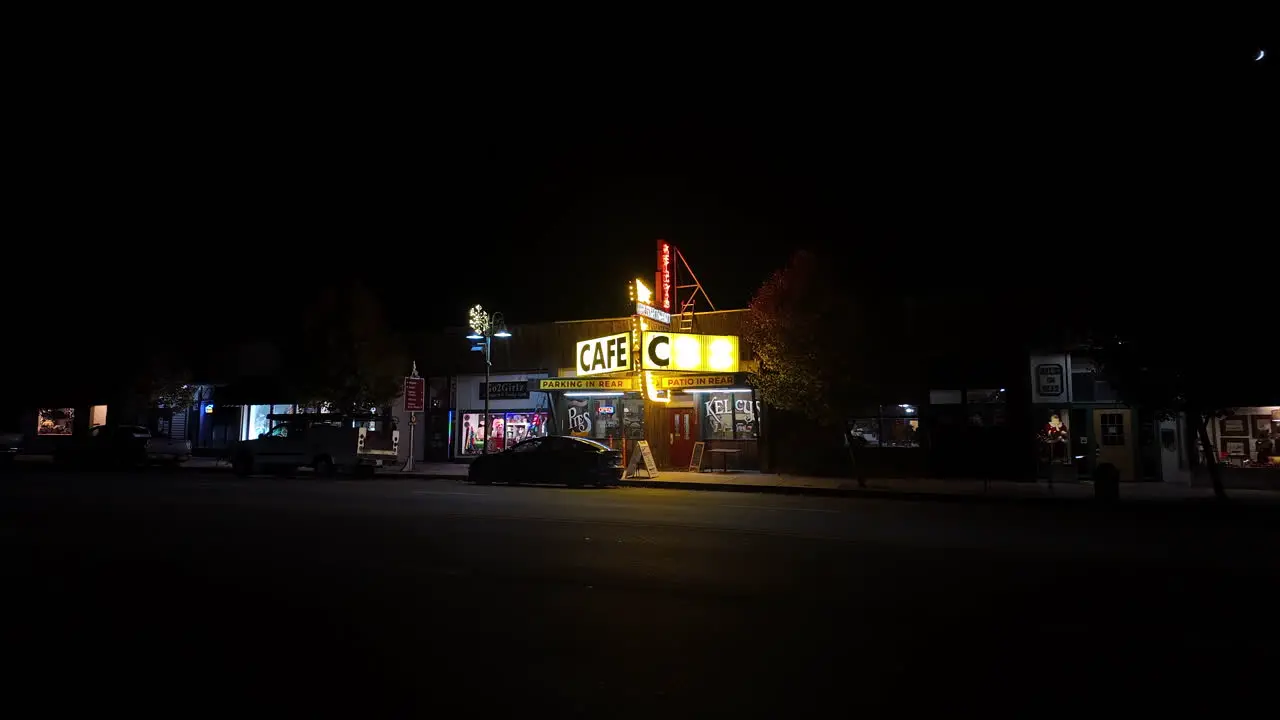 Roadside cafe diner with vintage neon sign at nighttime