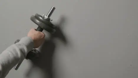 Overhead Studio Fitness Shot Of Hand Picking Up Gym Weight On Grey Background 1