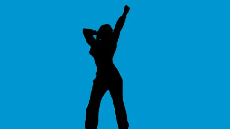 Studio Silhouette Of Woman Dancing Against Blue Background