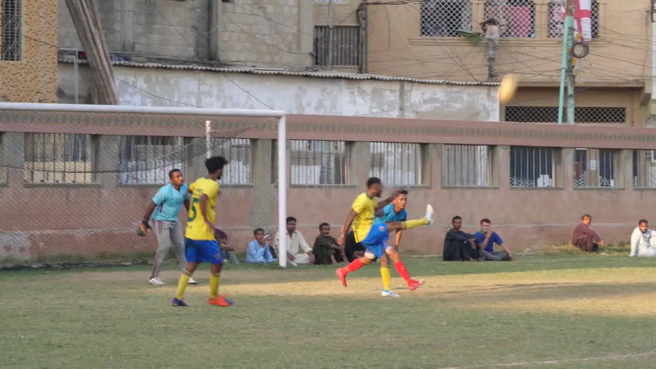 Close shot of kids playing football in the ground of Pakistan