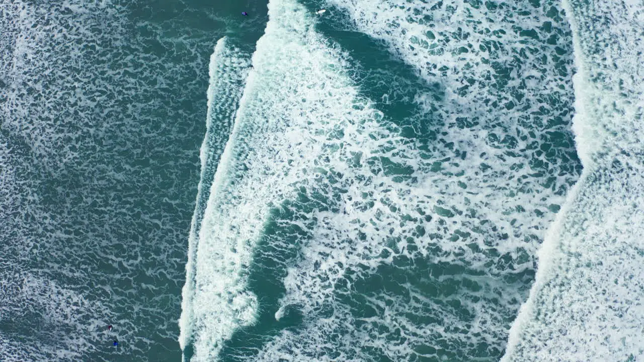 Drone shot of ocean waves crashing on the beach in British Columbia Canada