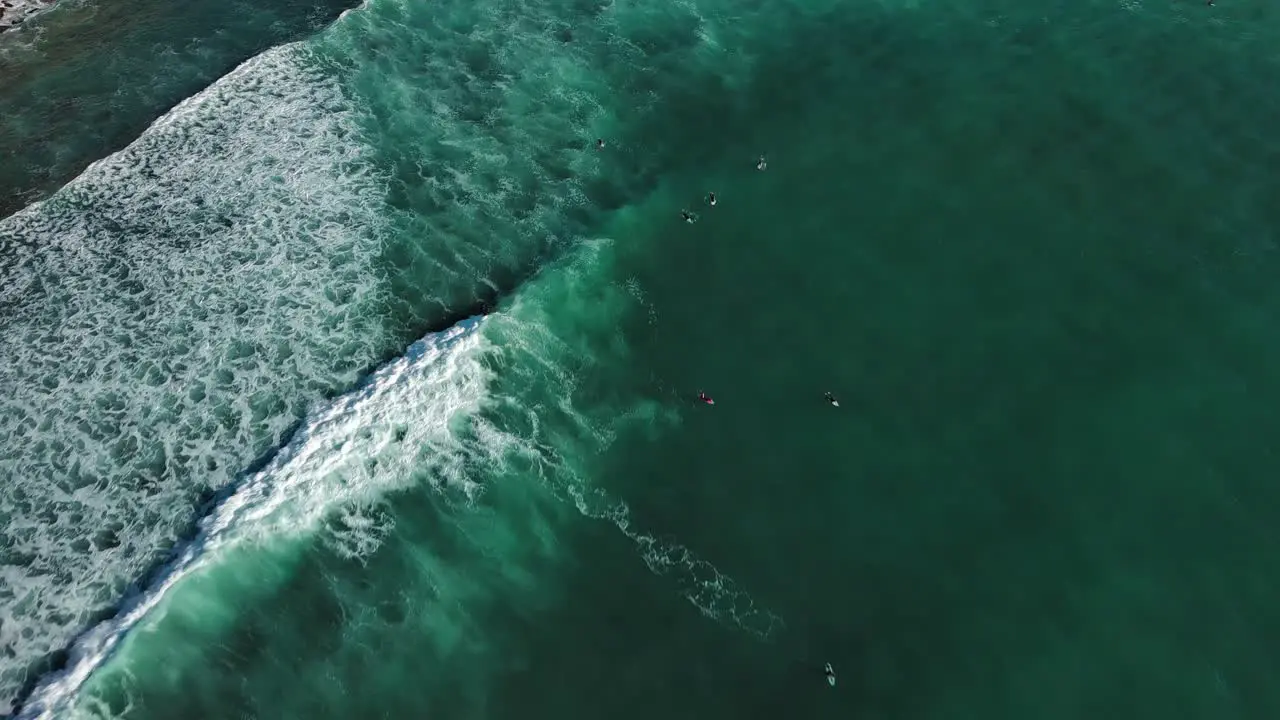 Surfers enjoying waves in Coast of Zumaia Spain drone view