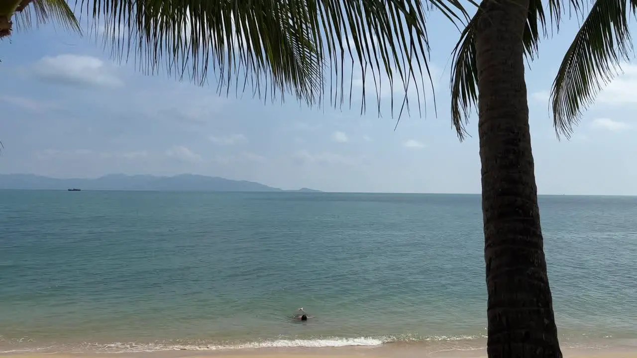 Person Swimming in Gulf of Thailand on Maenam Beach in Koh Samui Thailand