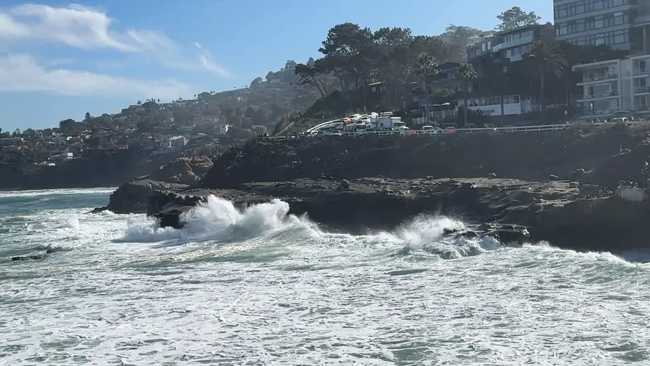 4K Slow motion footage of large ocean wave crashing and spraying at high tide in La Jolla Cove in San Diego California