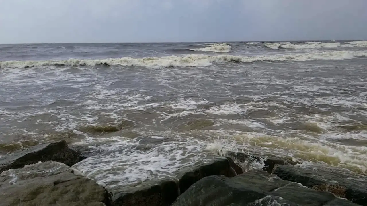 Waves from the Gulf of Mexico crashing into the rocks in Galveston Texas