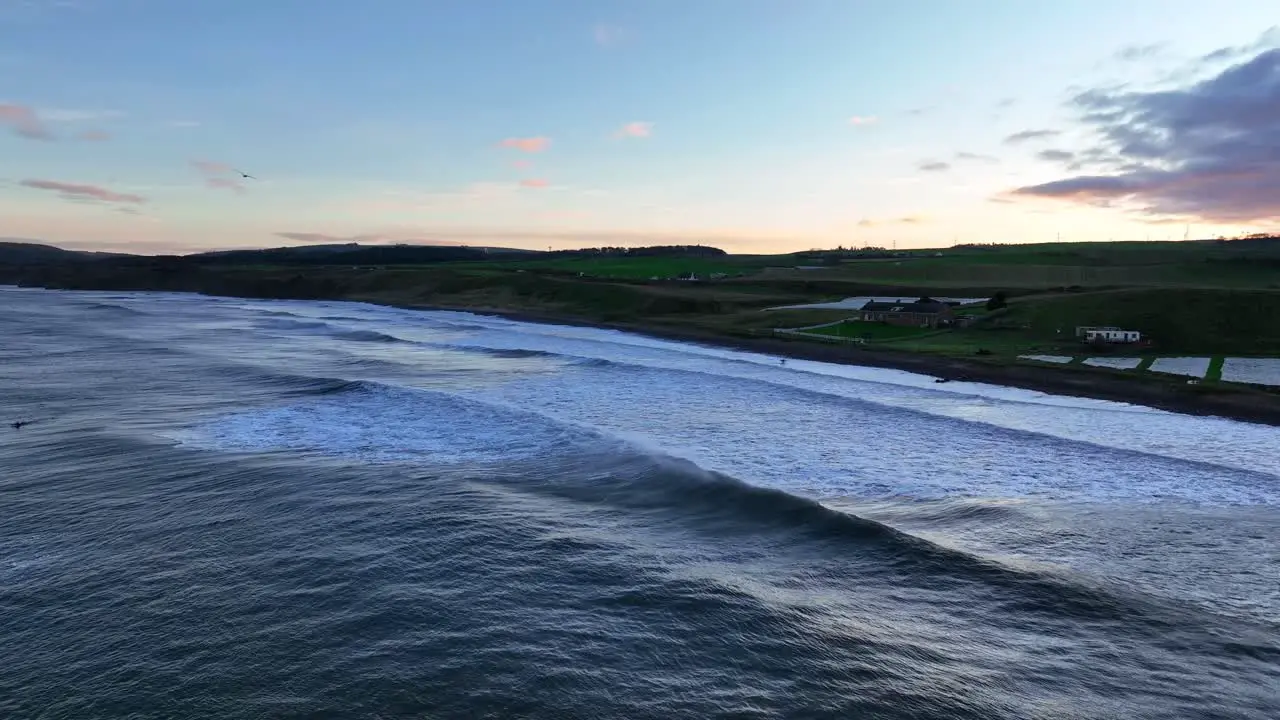 Dunbar's Ocean Canvas Aerial Surfers on the Scottish Coast at Thorntonloch Beach Scottish Beach at Sunset Scotland United Kingdom