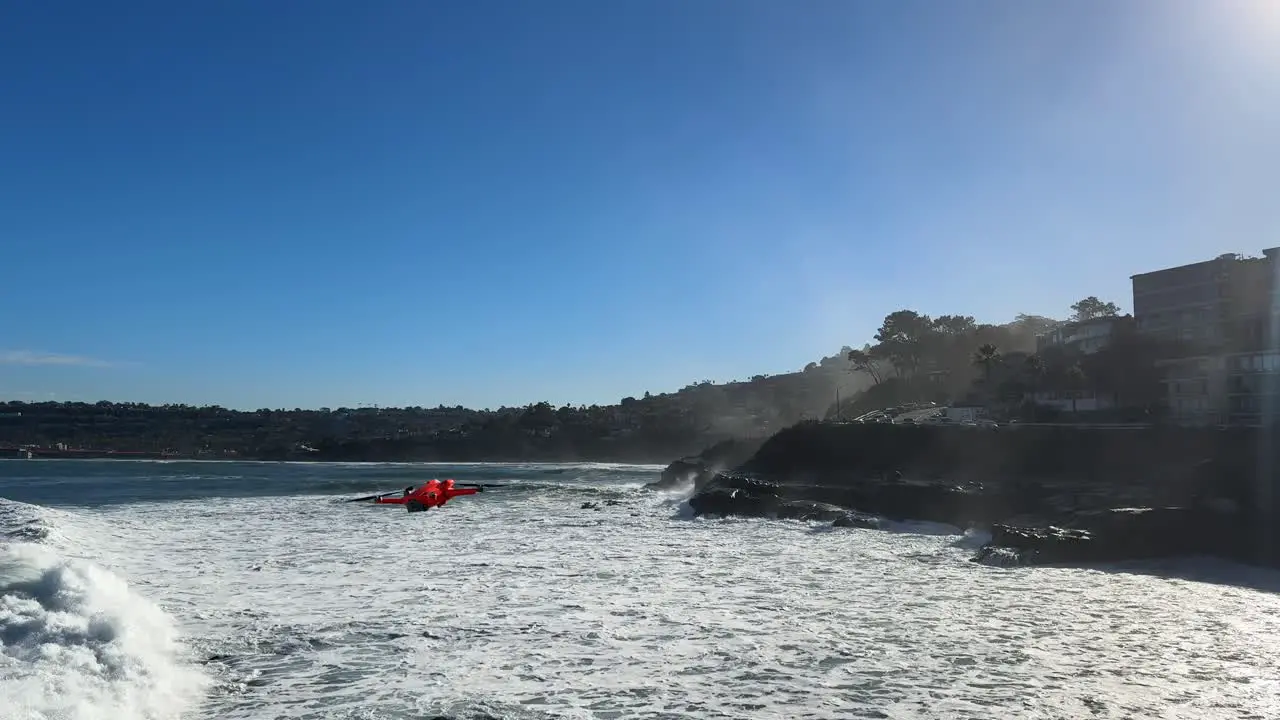 4K footage of drone flying over large ocean waves crashing on cliffs during high tide in La Jolla Cove San Diego California