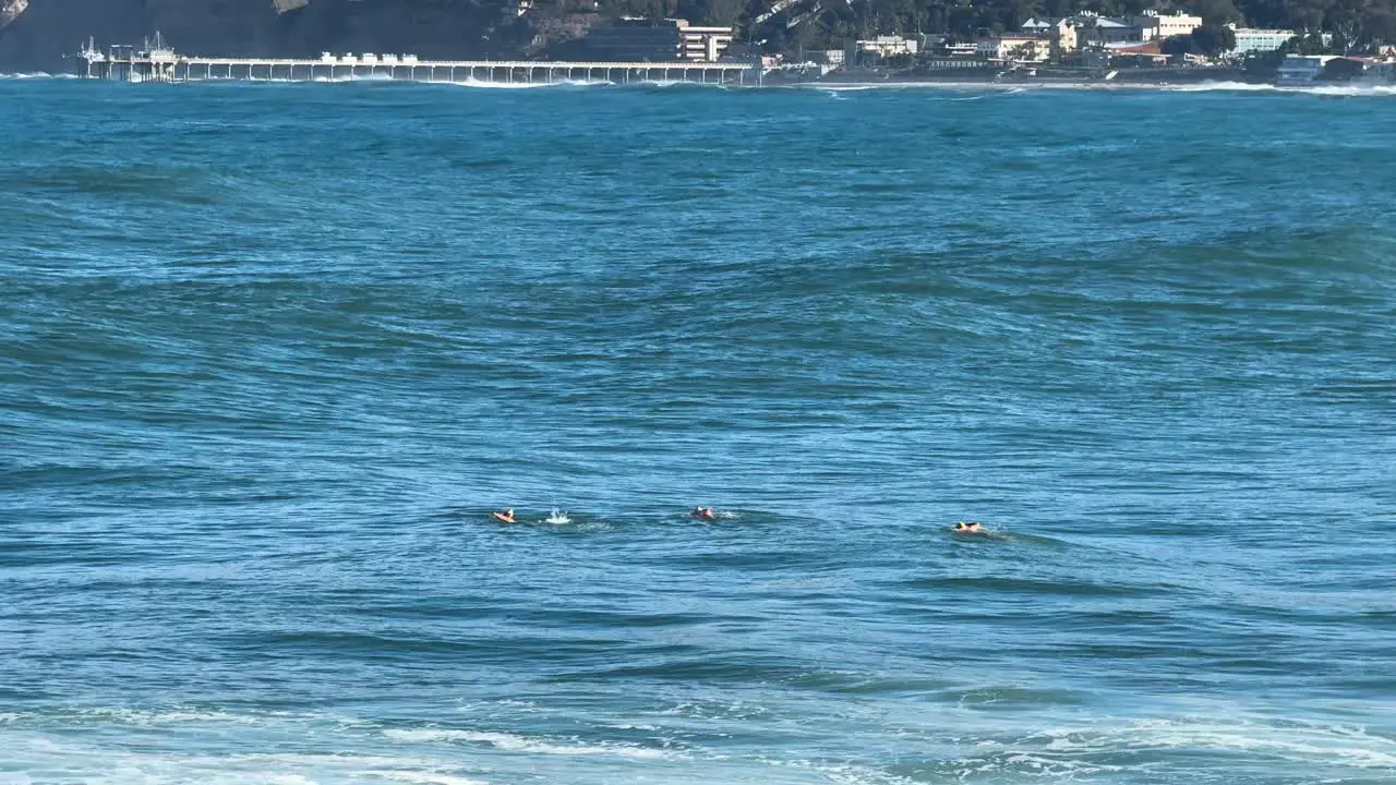 4K Footage of ruff water ocean swimmers with large waves at high tide in La Jolla Cove in San Diego California