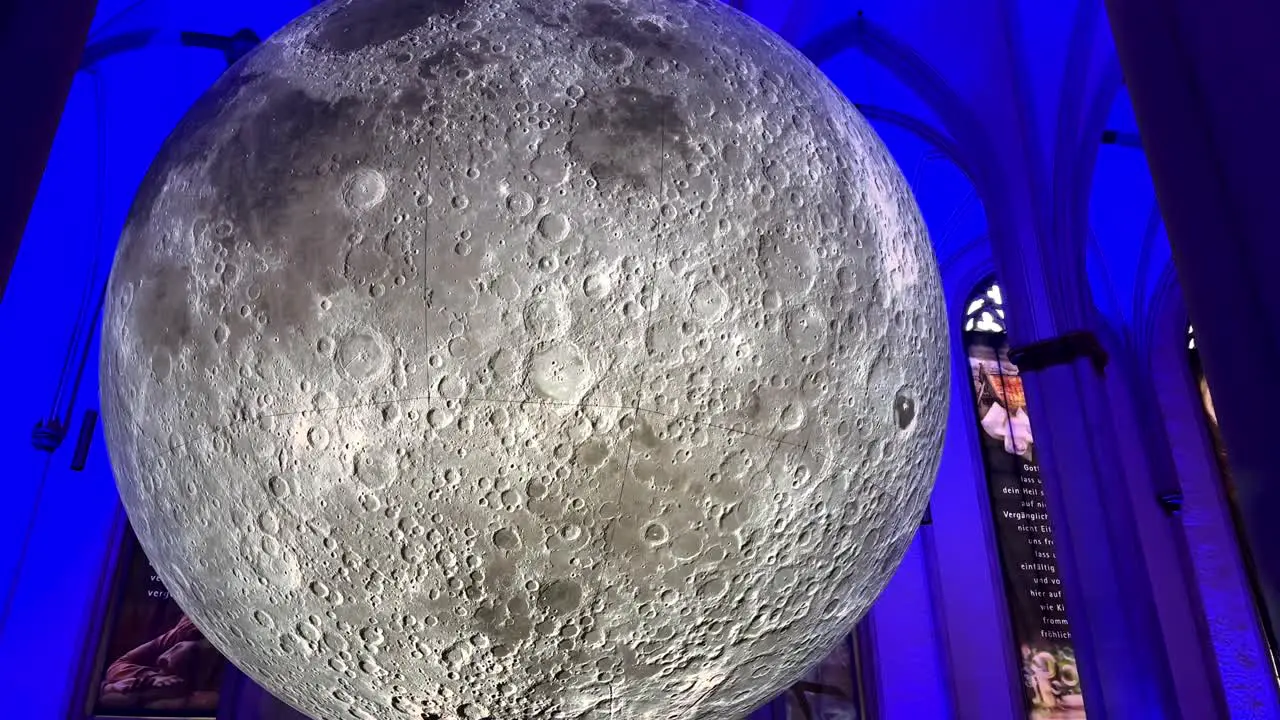 Tilt up shot of spectacular Museum of the Moon Artwork hanging in German church