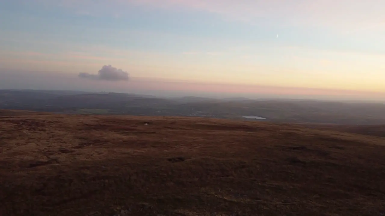 A 4K Aerial Drone Shot Rising Over Moor With a Lone Cloud