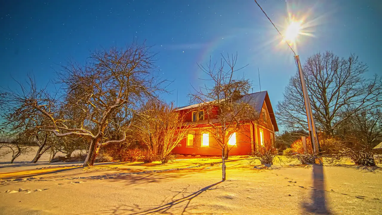 Moon and stars so bright that they cast shadows across the snow in the backyard of a countryside home time lapse