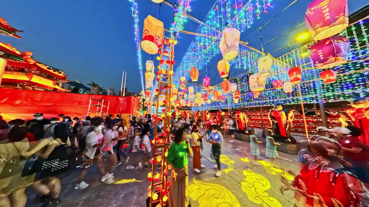 Night motion timelapse of colorful lanterns and people celebrating Mid-Autumn Festival in Wong Tai Sin Temple Hong Kong