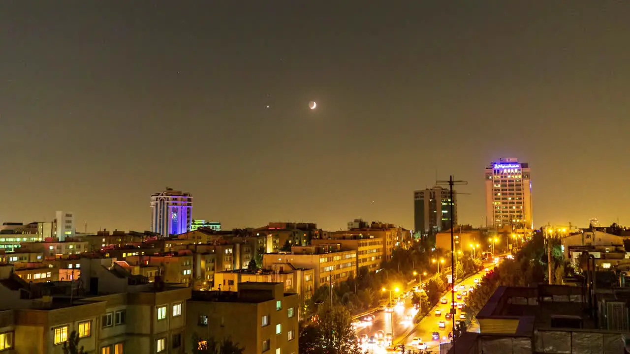 Sunset Moonset in Iran city landscape urban lifestyle in modern country in middle east asia saudi arabia tourism destination golden color twilight planet astronomical night sky time lapse car driving