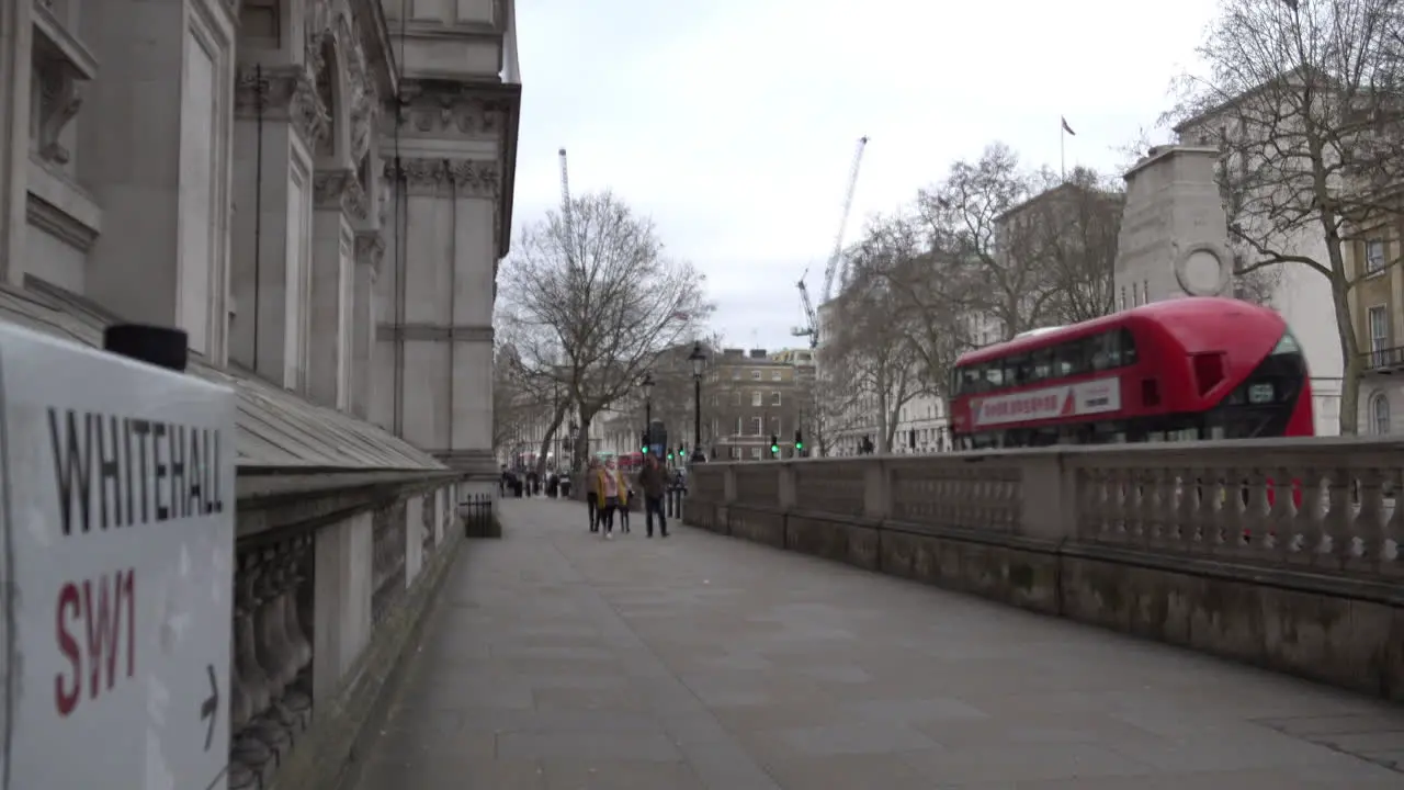 A family walks along an almost deserted Whitehall the day after Prime Minister Boris Johnson warns the UK population to avoid all non-essential social contact due to the Coronavirus outbreak