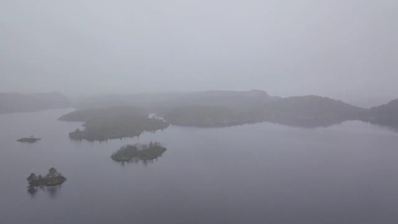 Drone shot flying through thick fog in the countryside of Norway