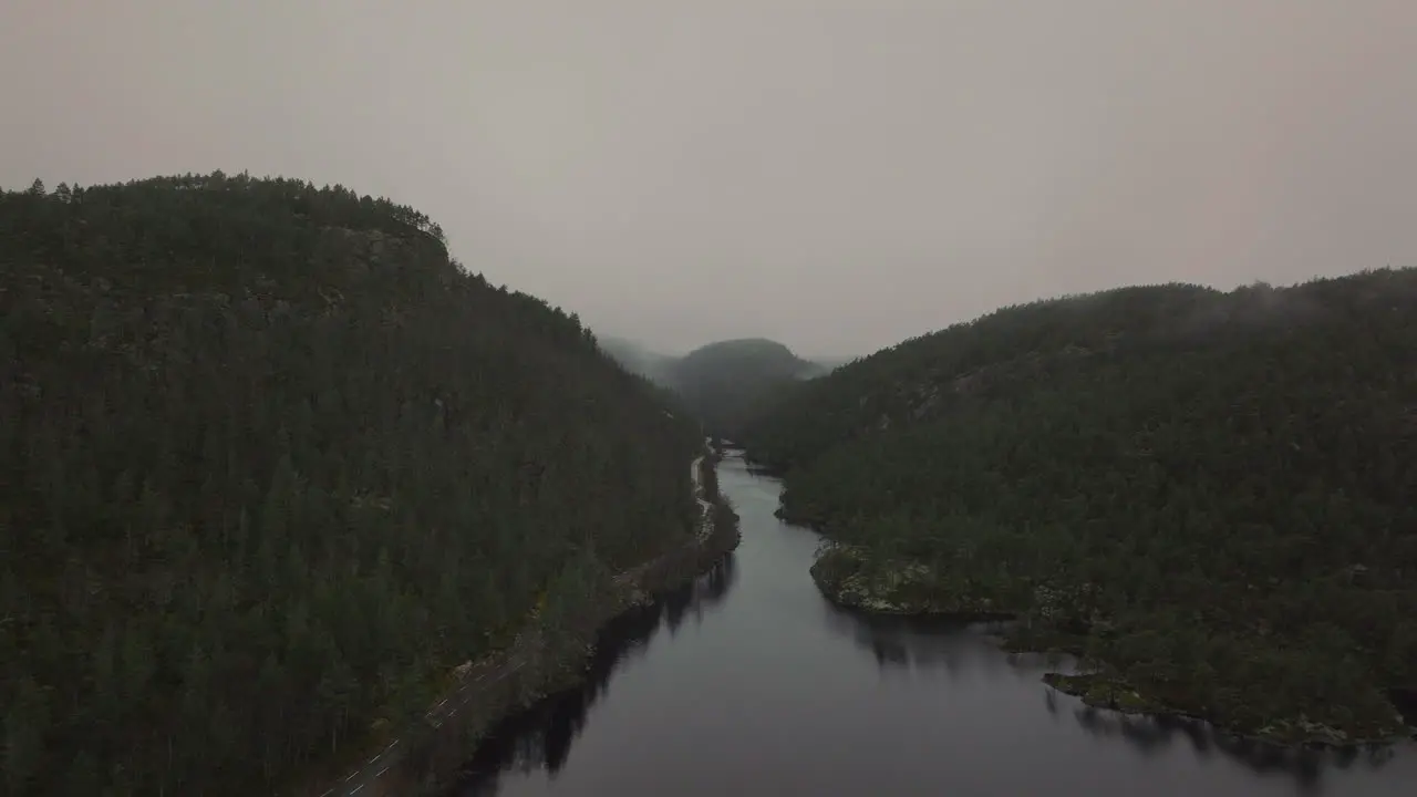 Drone shot flying through mist and fog in a mountain valley Norway