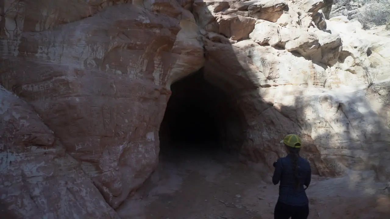 Woman With Camera Entering Belly of the Dragon Man Made Tunnel in Utah USA