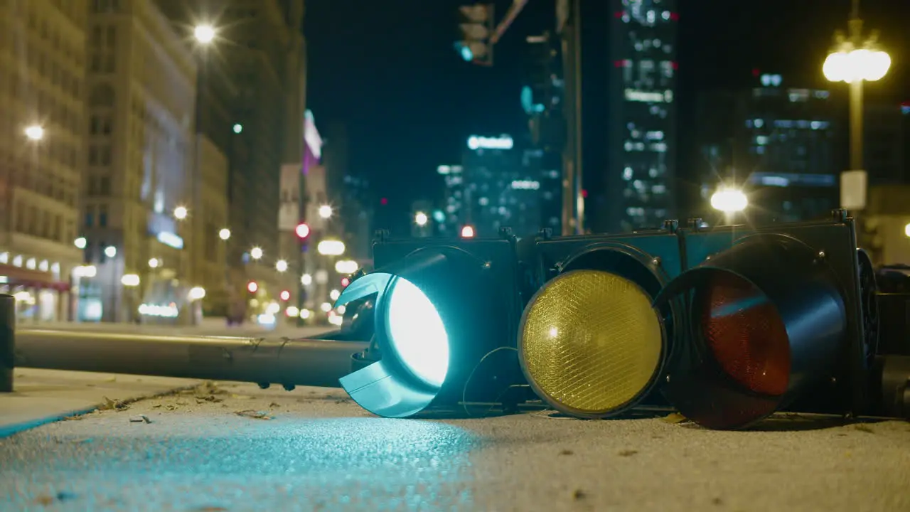 A downed light post switches from red to green on Michigan Ave in Chicago at night