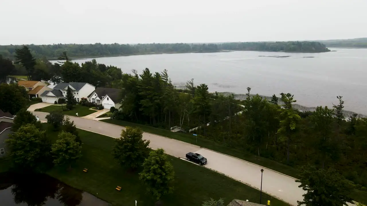 Suburban neighborhood situated on a calm but cloudy lake