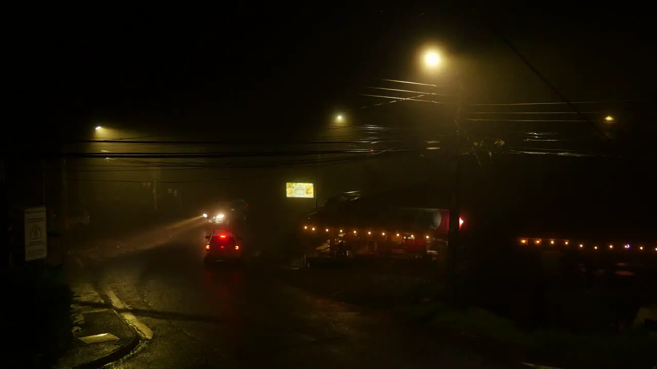 Cars driving on a misty road at night