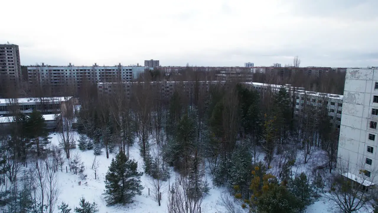 Flyover above Pripyat evacuated city near Chernobyl in winter snow