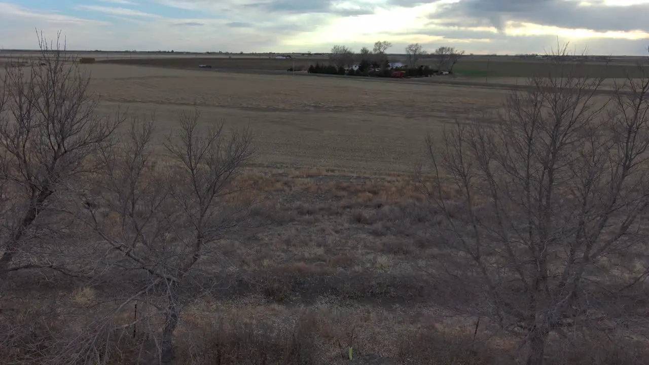 An aerial dolly pan over trees on a dry farm near Sterling Colorado 2021