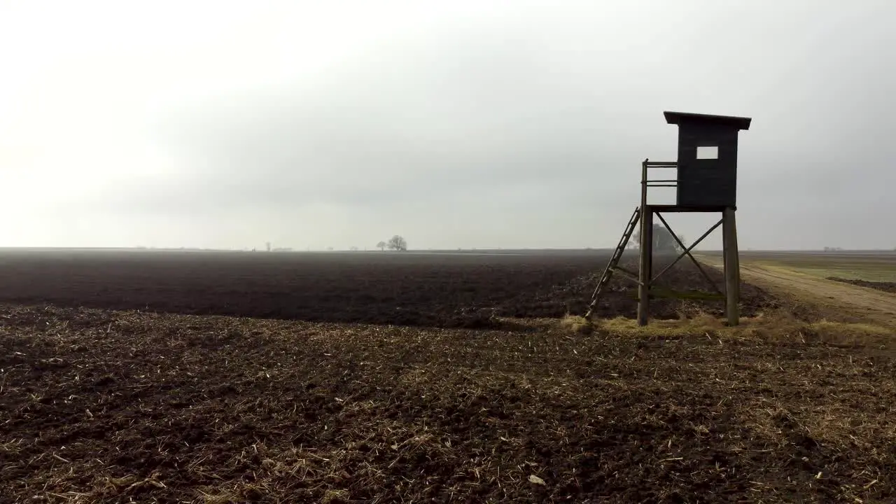 Slow drone ride over cleared mystic corn field with high stand in austria